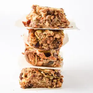 A stack of four granola bars tilting to the right with a white background