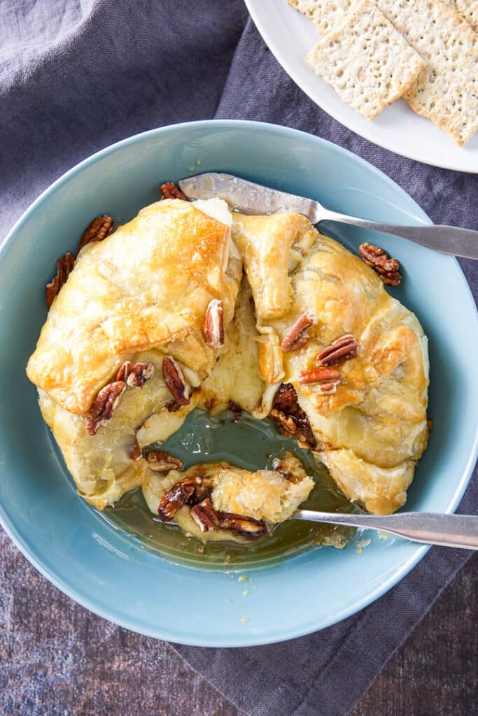 Overhead view of the brie with a small knife and forkful of the cheese
