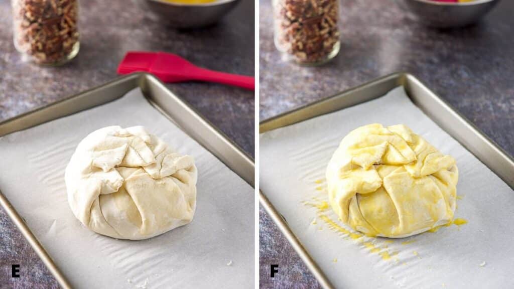 Puff pastry folded over the brie and on a jelly roll pan covered with parchment paper. There is an egg wash over the puff pastry