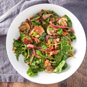 Square photo of the salad in a shallow bowl and on a grey napkin