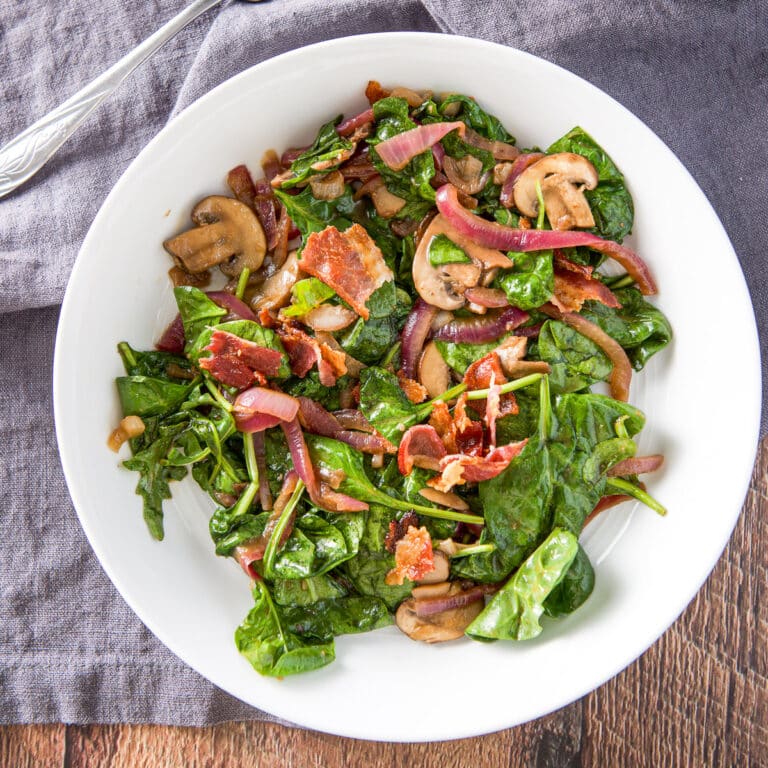 Square photo of the salad in a shallow bowl and on a grey napkin