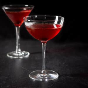 Bowl glass in front of the classic glass filled with the Manhattan