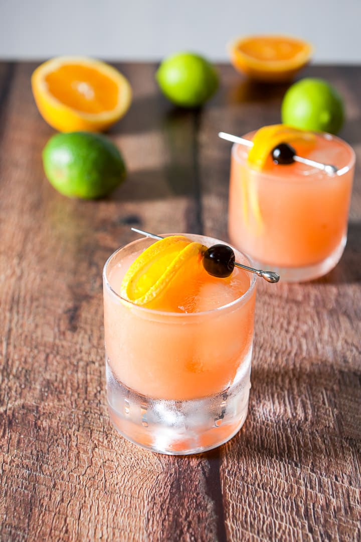 The glass with the big bottom in front filled with the cocktail and the double old fashioned glass in the background
