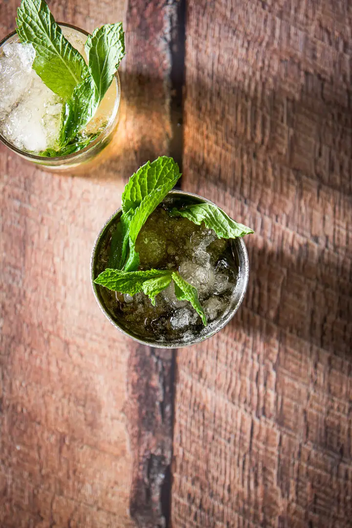 Overhead view of the two glasses filled with the julep with mint sticking out of the glasses