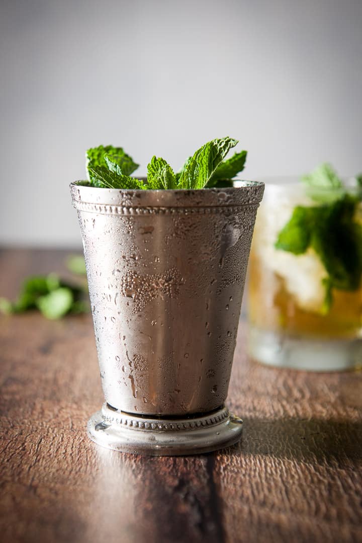 Vertical view of the sterling silver glass with the julep in it and mint sticking out of it