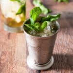 Square photo of a metal cup with the julep in it with fresh mint in as a garnish