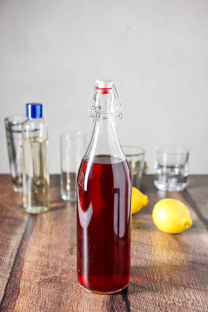 Cherry vodka, lemons, simple syrup and glassware and the cocktail shaker in the background