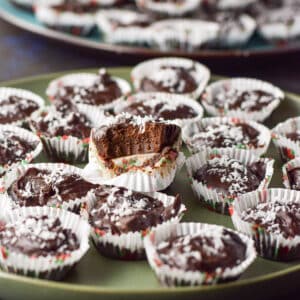 A truffle with a bite taken out of it on the plate of truffles - square