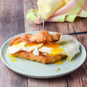 A croissant with cheese, egg and ham - square