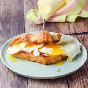 A croissant with cheese, egg and ham - square