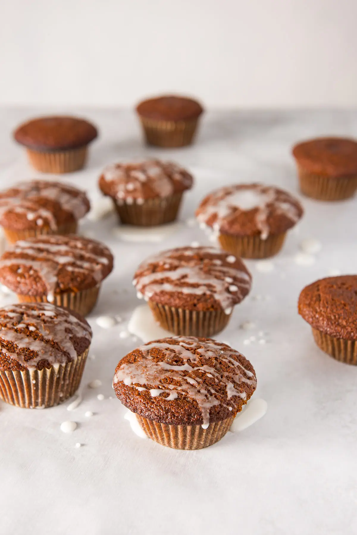 Glazed muffins on parchment paper