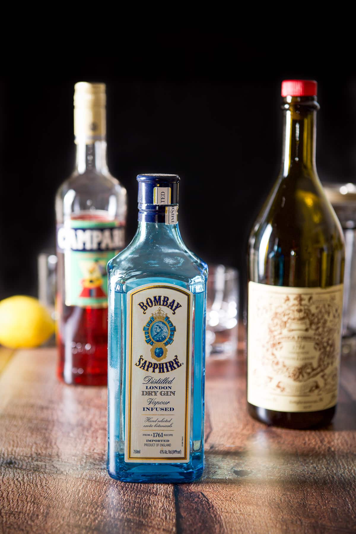 Gin, sweet vermouth, campari with the glassware and shaker in the background