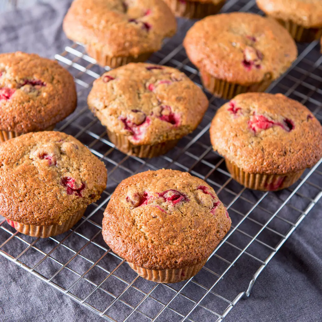 Cranberry muffins cooling on a wire rack - square