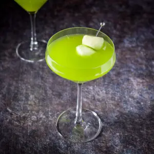 The curved martini glass filled with the melon cocktail - square