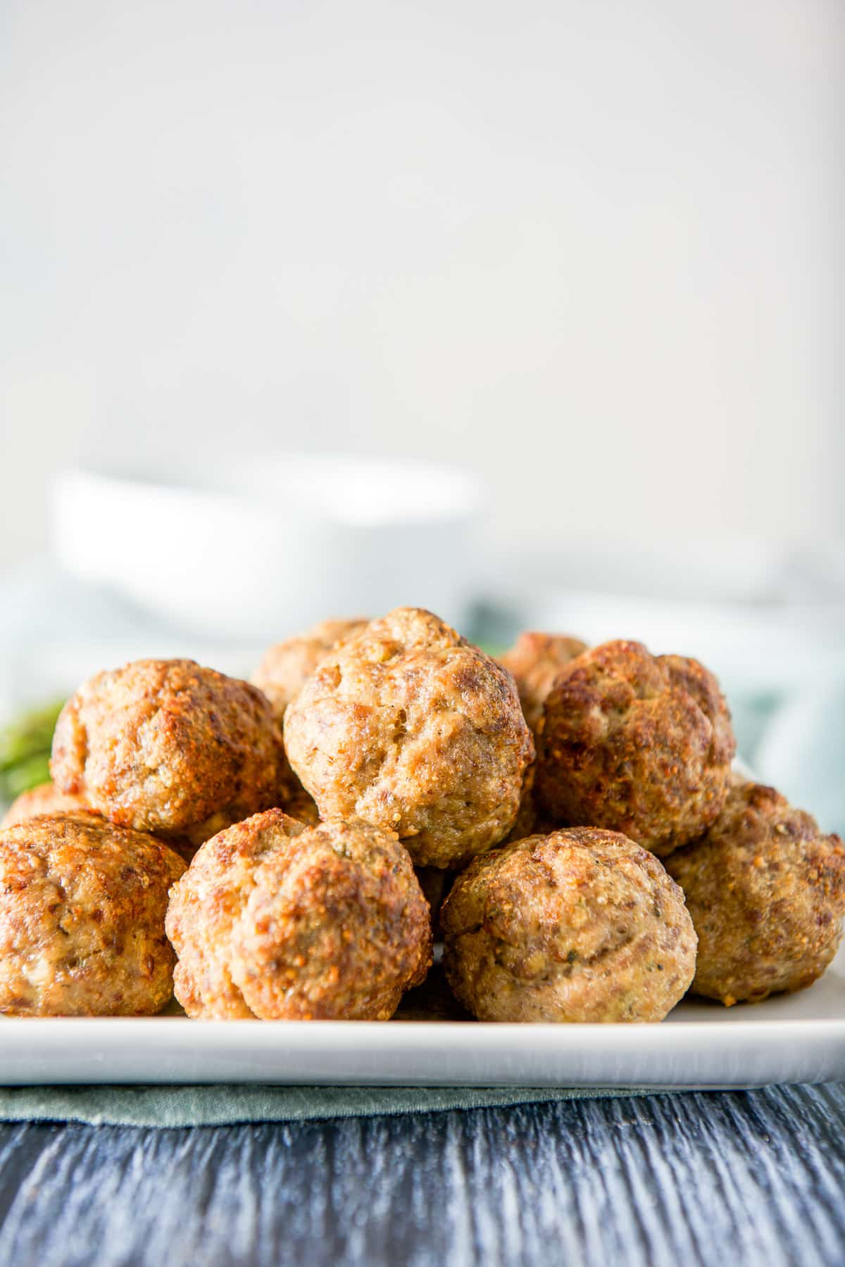 Vertical view of a white plate with a pyramid of meatballs