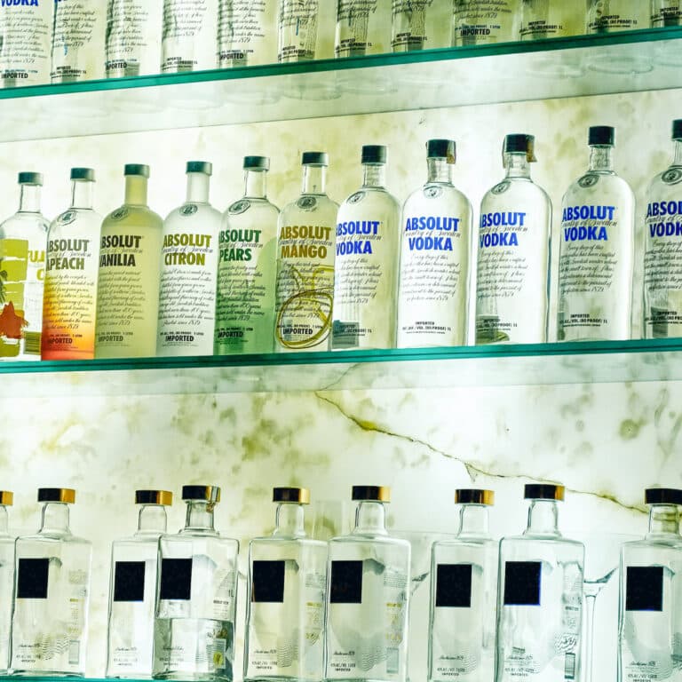 Three rows of vodka on shelves - square