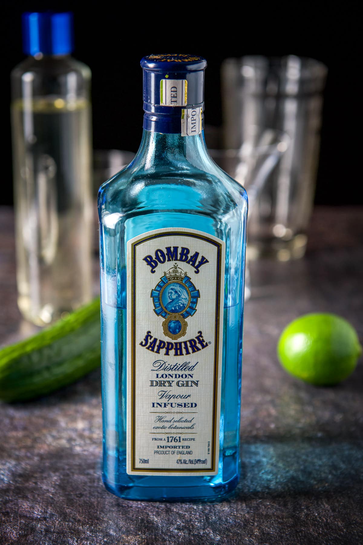 Gin, lime, cucumber, simple syrup with shaker in the background