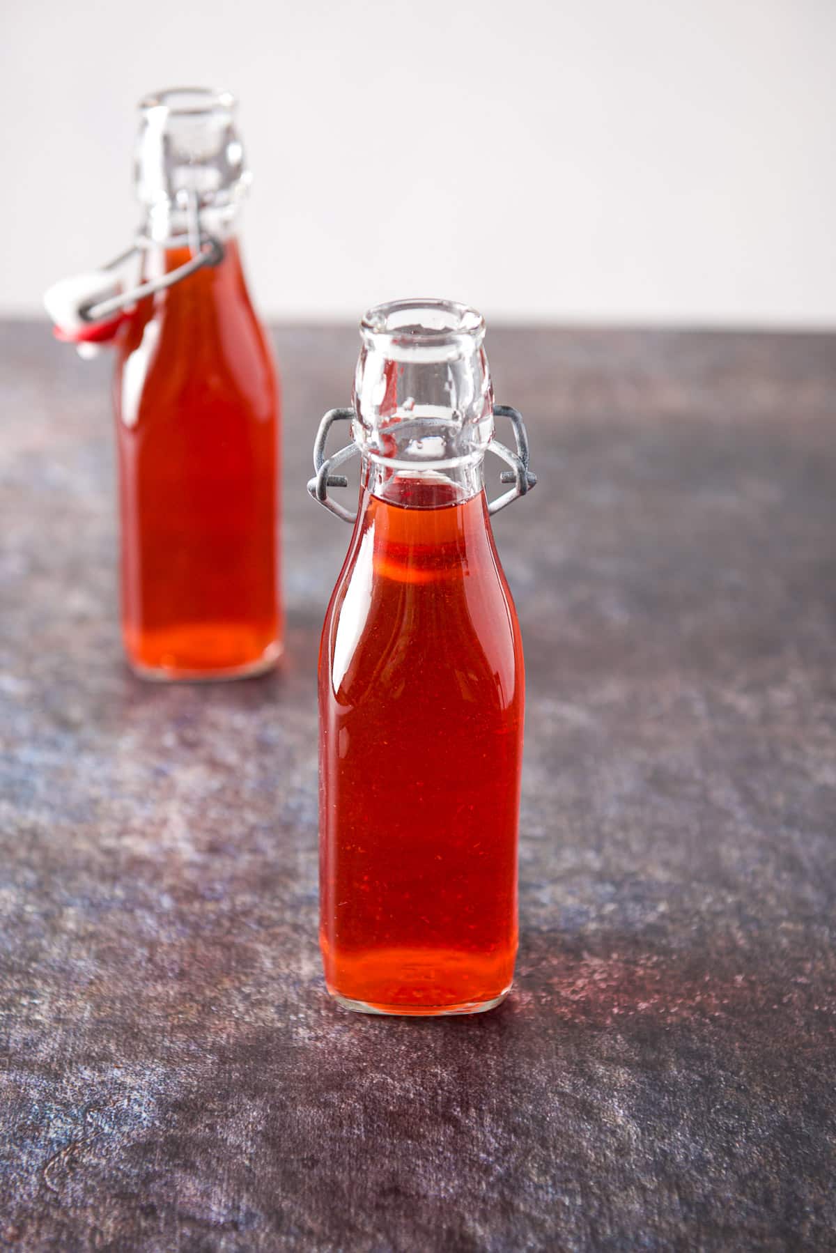 Two bottles of red vodka on a table