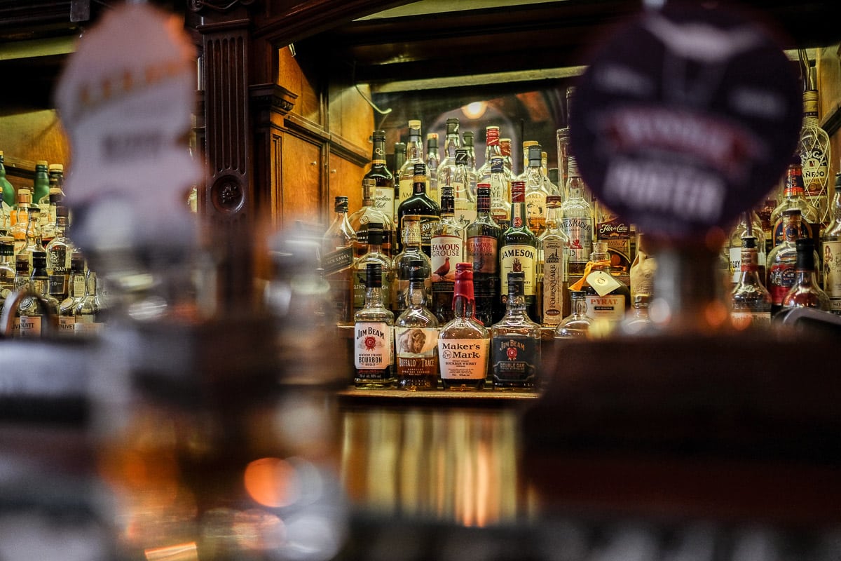 A bar with a bottles of whiskey on display