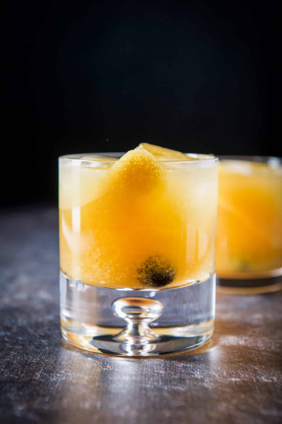 Vertical view of the bubble glass filled with the amaretto stone sour