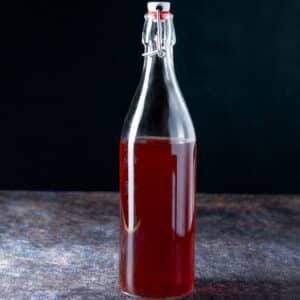 A bottle of red vodka on a table