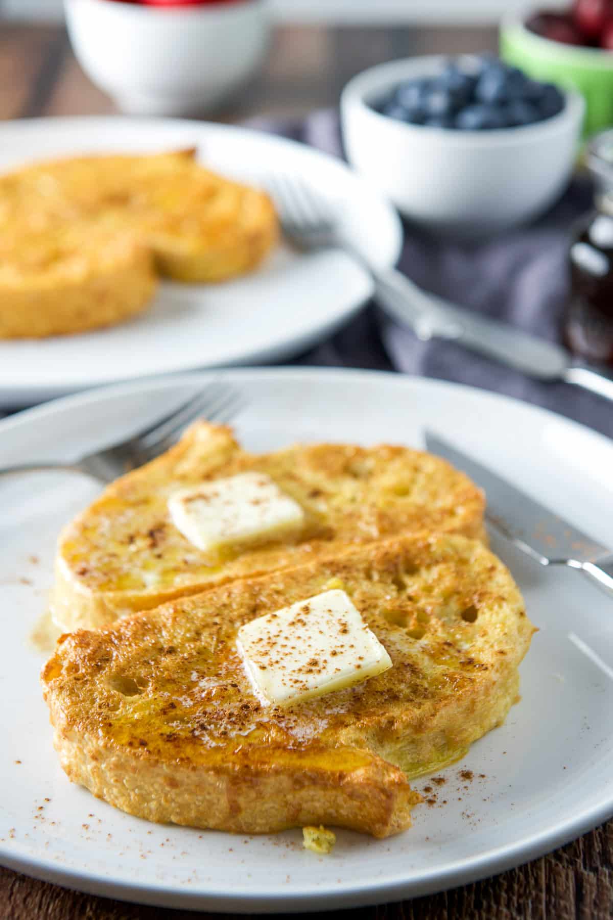 Butter, and cinnamon on the French toast with fruit in the back