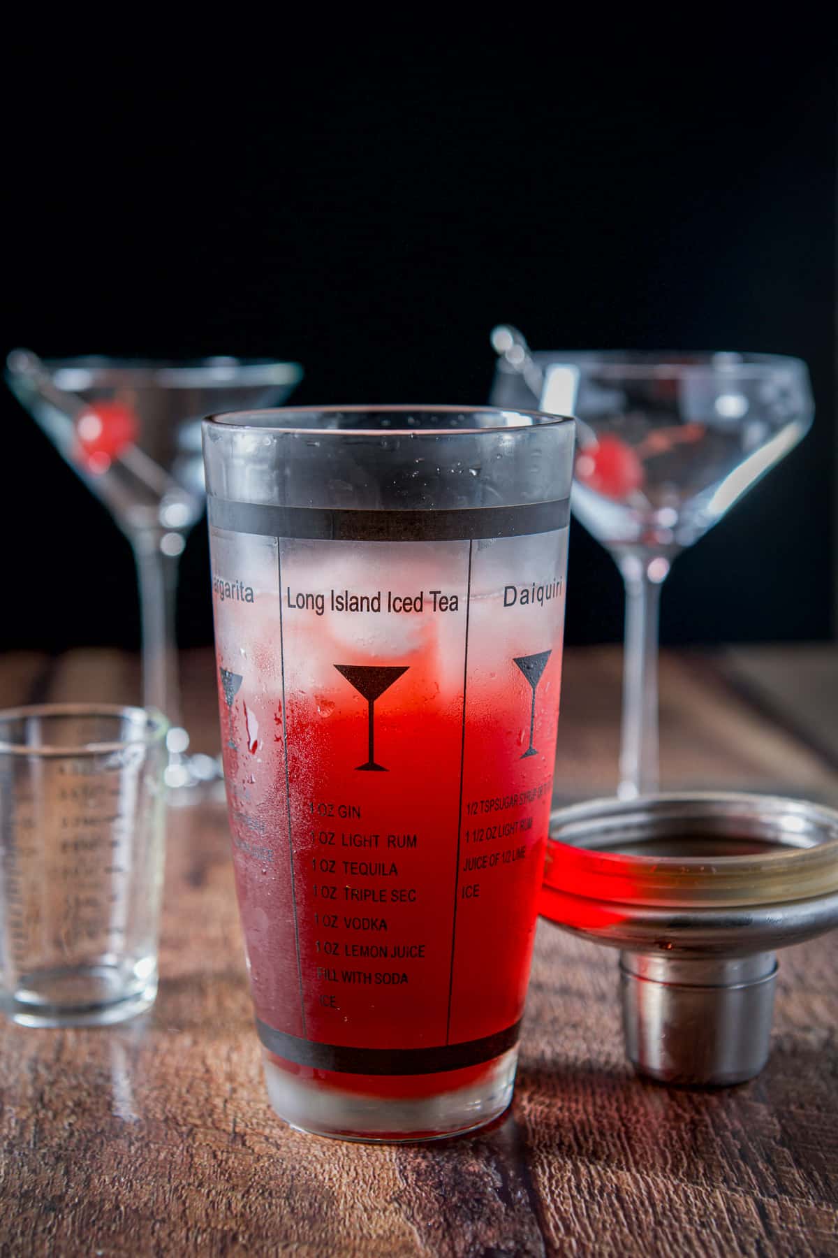 Champagne poured into the shaker with the red cocktail