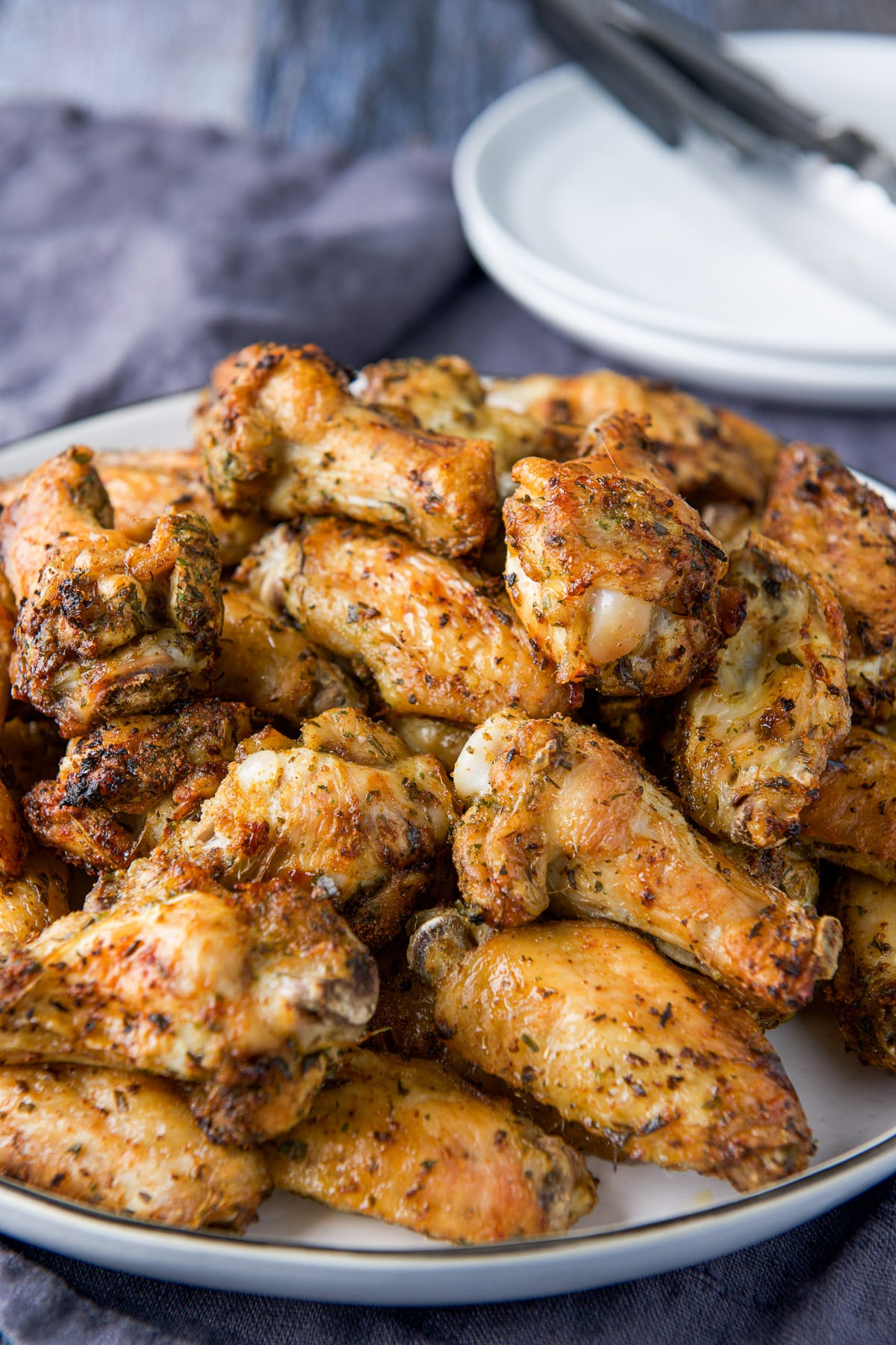 Close up of the chicken wings with a white plate in the background
