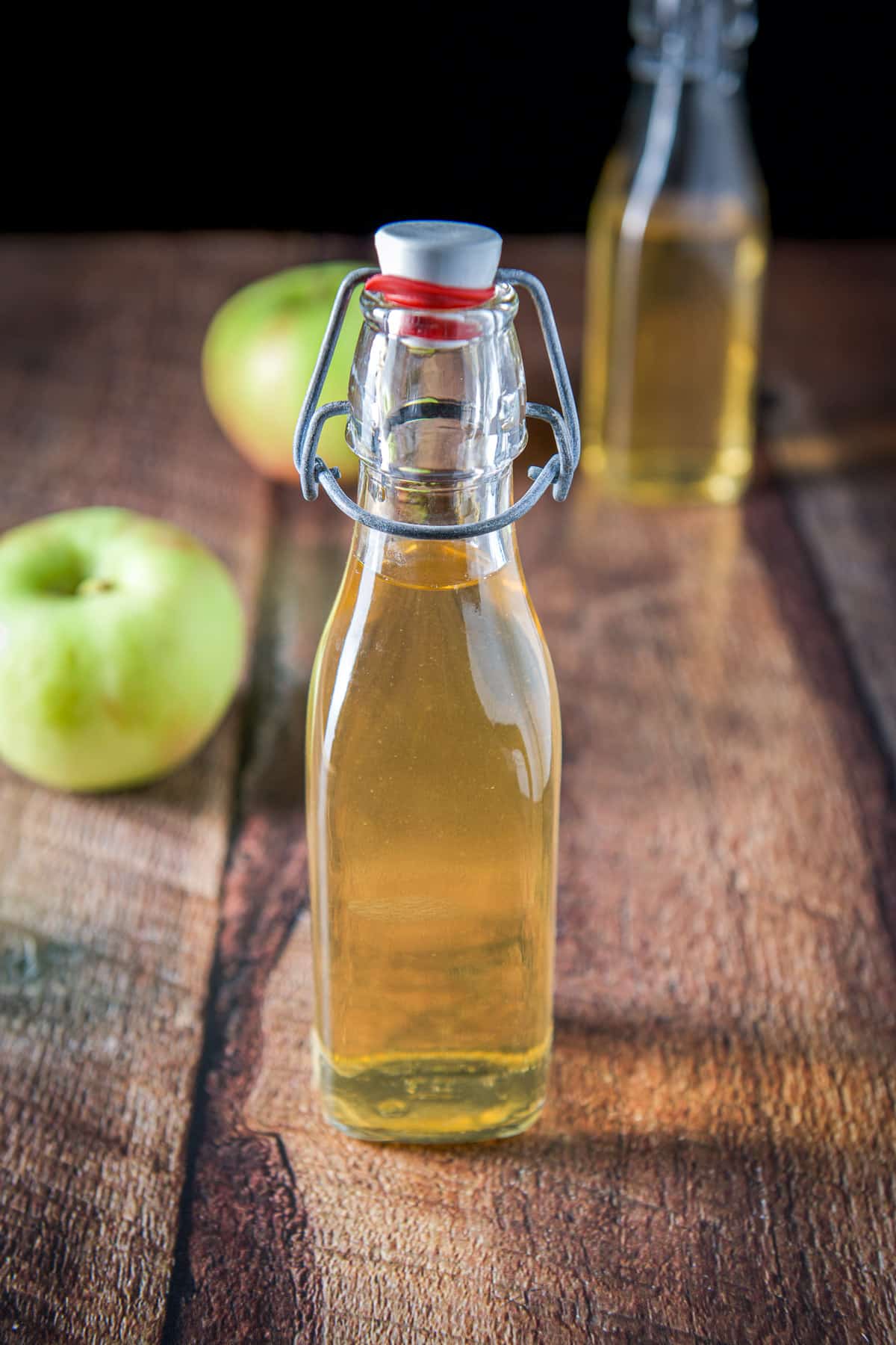 A little bottle of vodka that has been flavored with another in the back