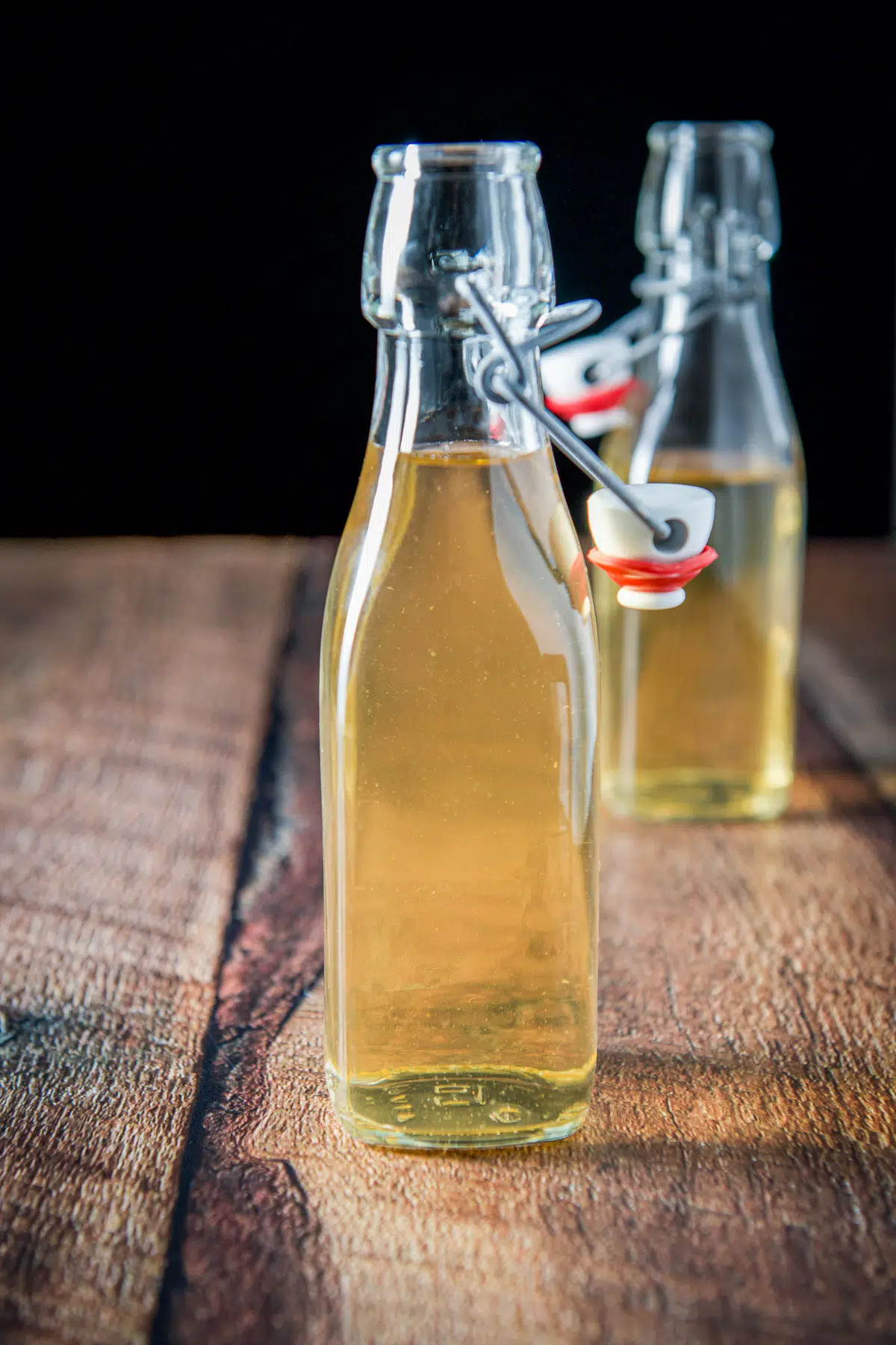 Two flavored vodka in jars without the lid on