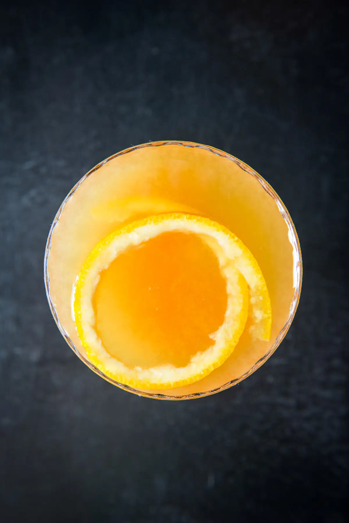 Overhead view of the orange rind floating in the orange drink