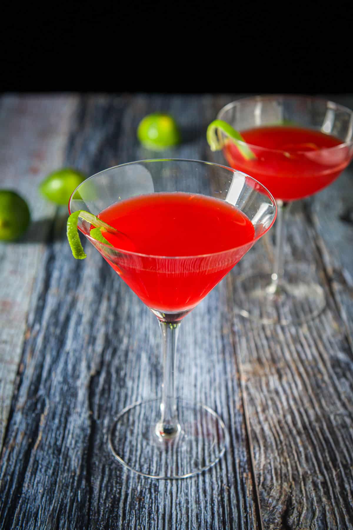 Classic martini glass filled with the Charlie Chaplin in front of the bowl glass