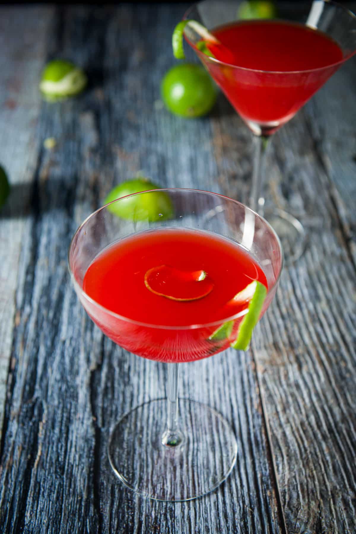 Bowl glass filled with the red drink in front of the classic glass