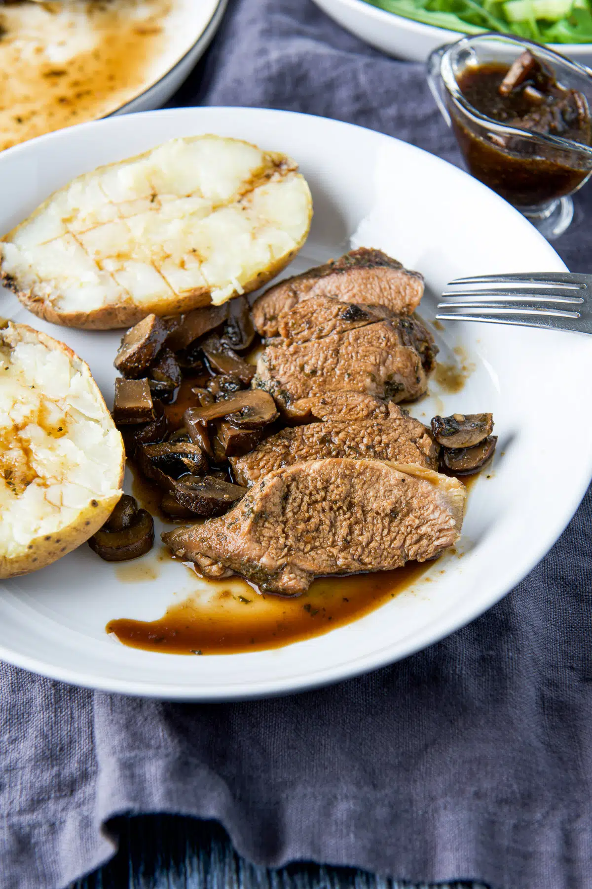 Pork slices with marinade on it with mushrooms and potato