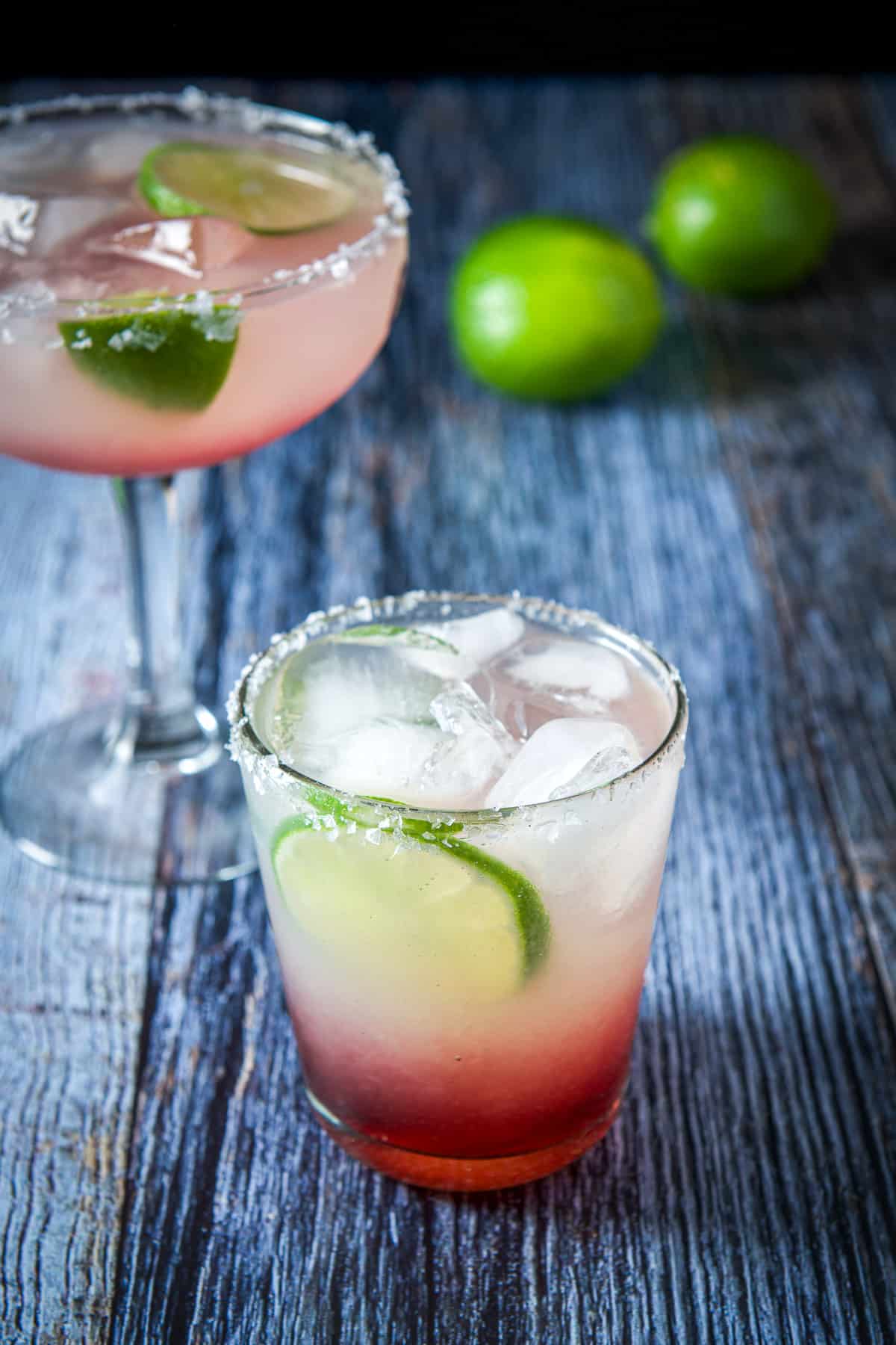 The old fashioned glass filled with the margarita with the bowl glass behind it