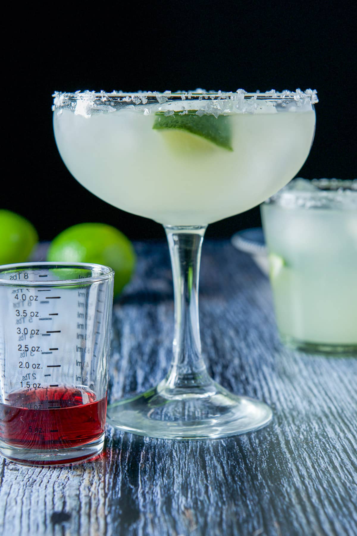 Chambord in a glass waiting to be added to the margarita in a bowl glass