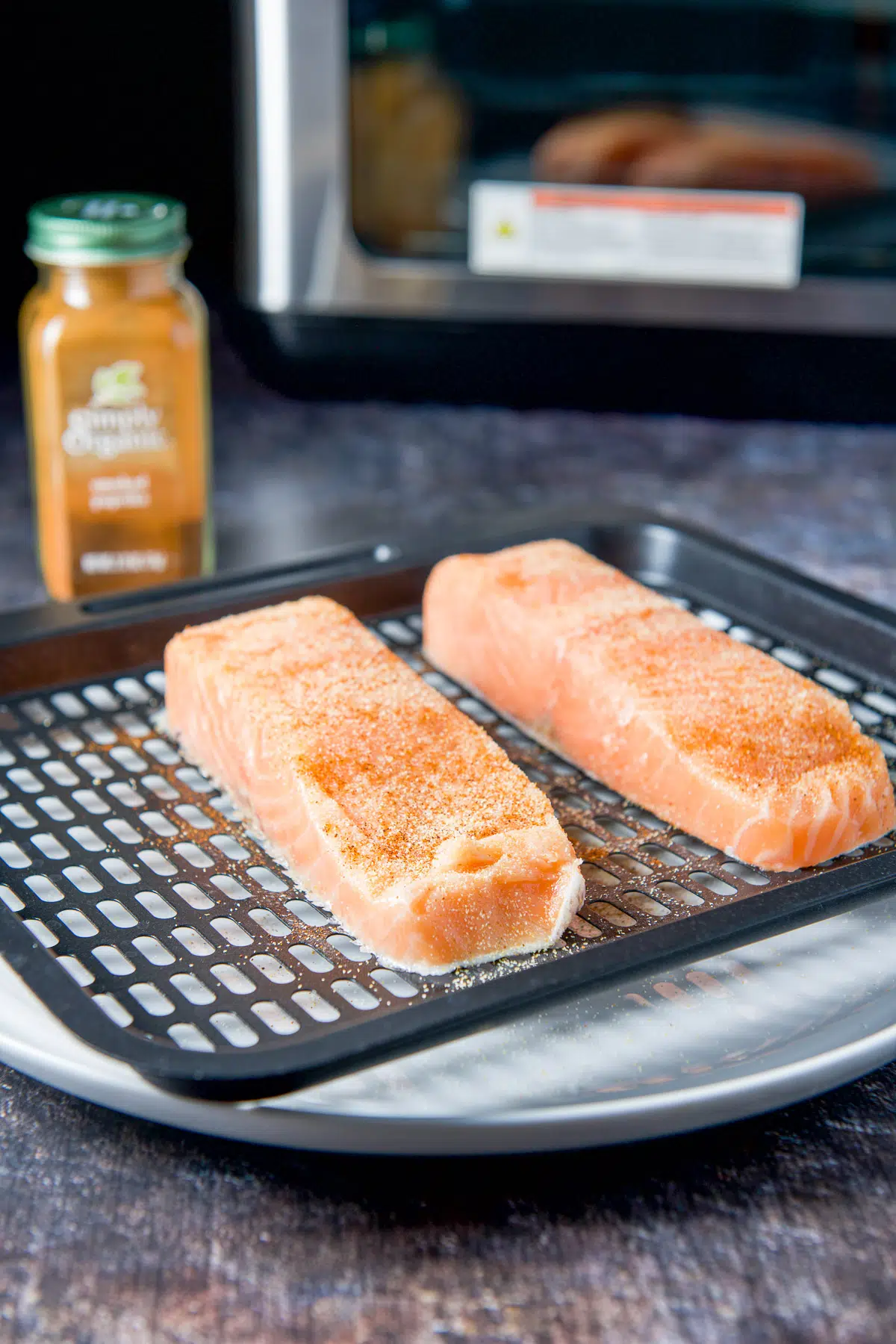 Smoked paprika sprinkled on the salmon on the tray