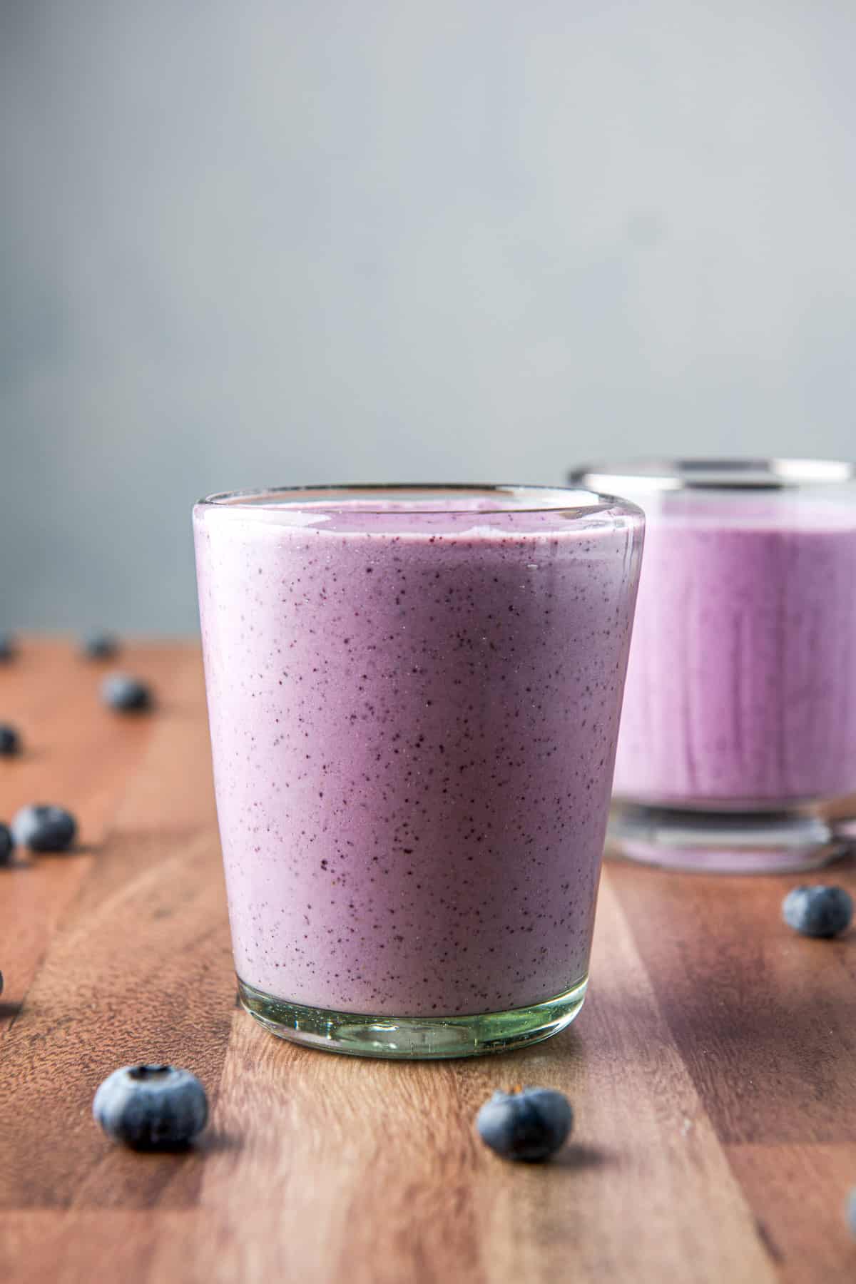 Vertical view of the smooth glass filled with the blueberry smoothie