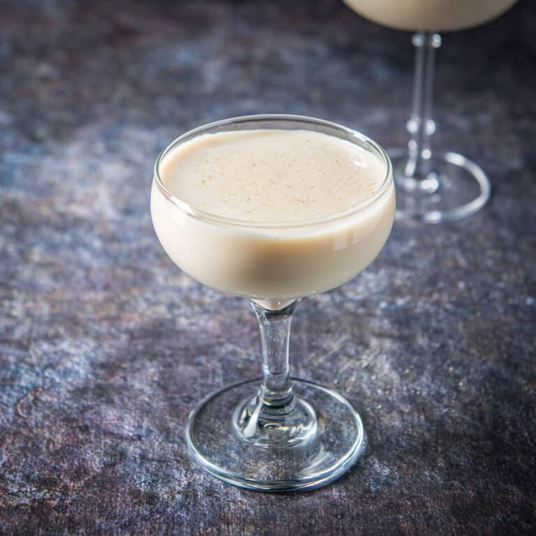 A coupe glass with the creamy cocktail - square