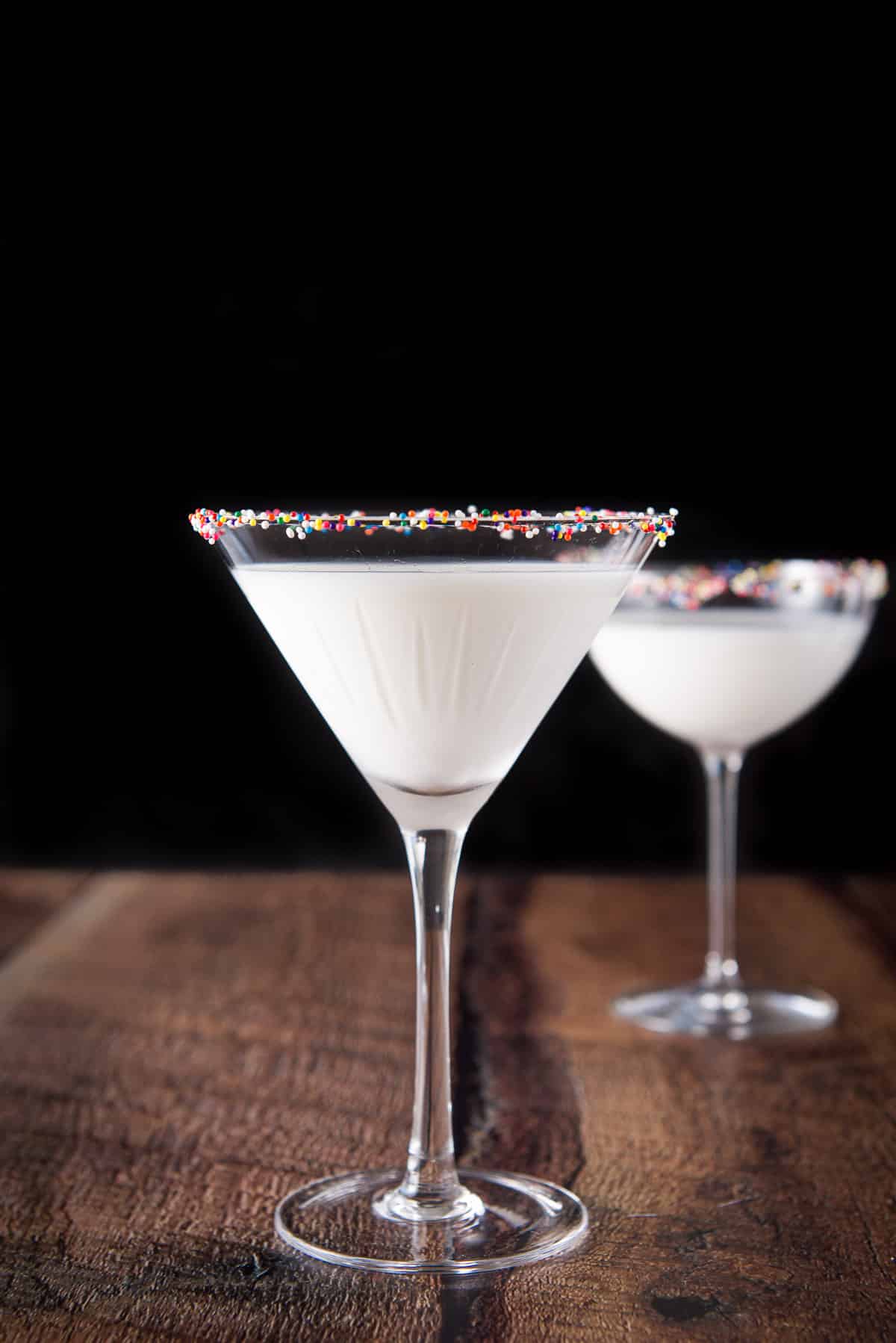 The classic martini glass in vertical view with the cream martini in it