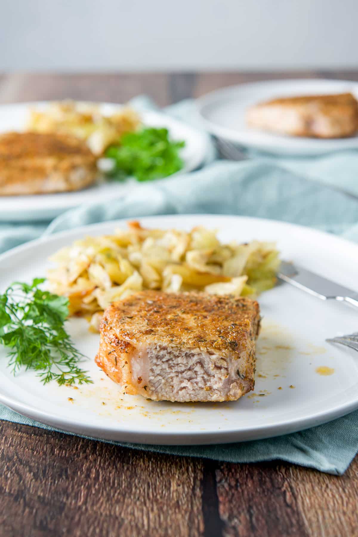A higher view of the piece of pork chop with a slice taken out