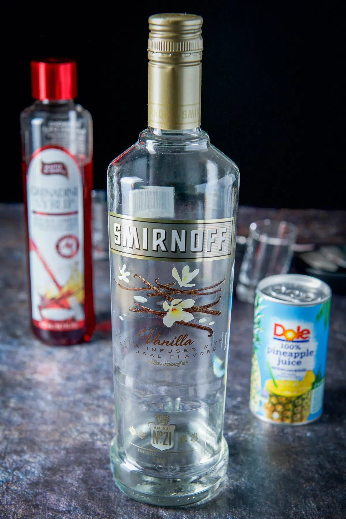 Vanilla vodka, pineapple juice and grenadine on the table