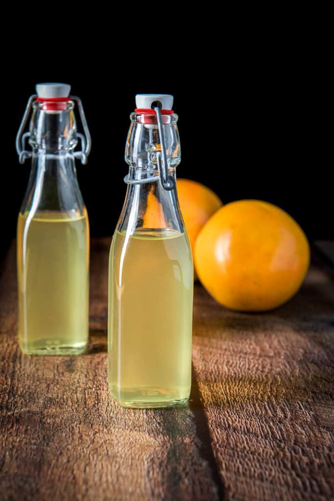 Vertical view of the two bottles with the grapefruit vodka in it