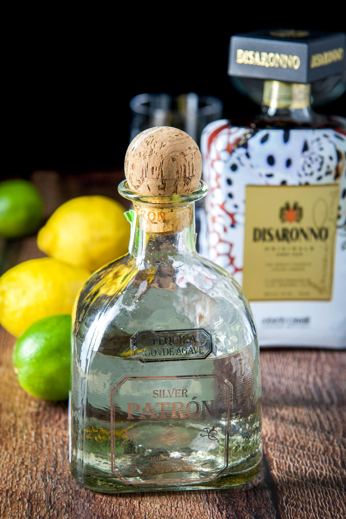 Tequila, amaretto, lime and lemons on a table