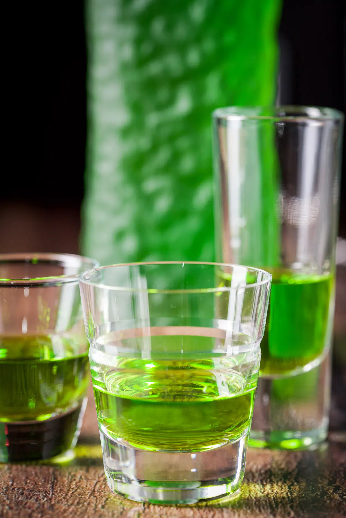 Midori poured into three glasses with the bottle in the back