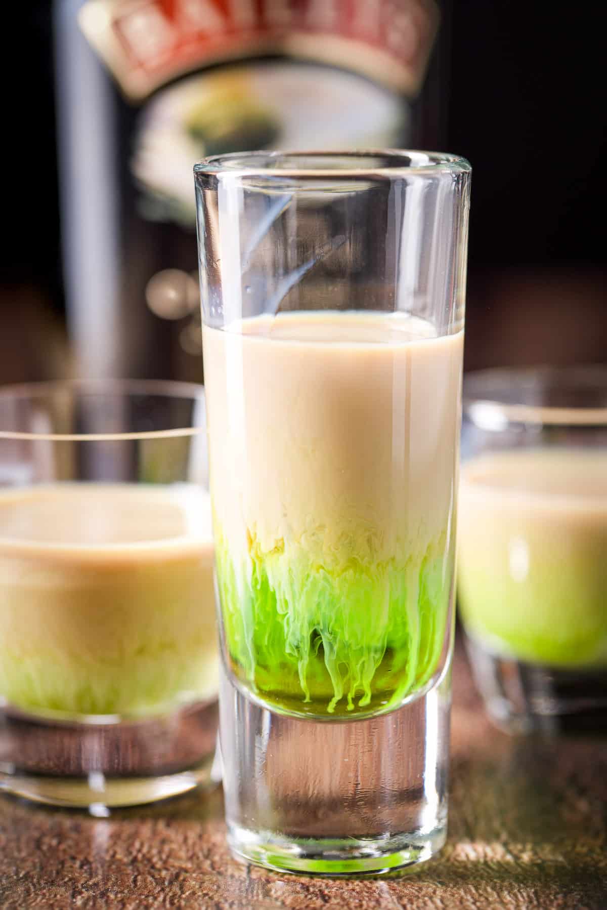 Baileys layered in the glasses with the bottle in back