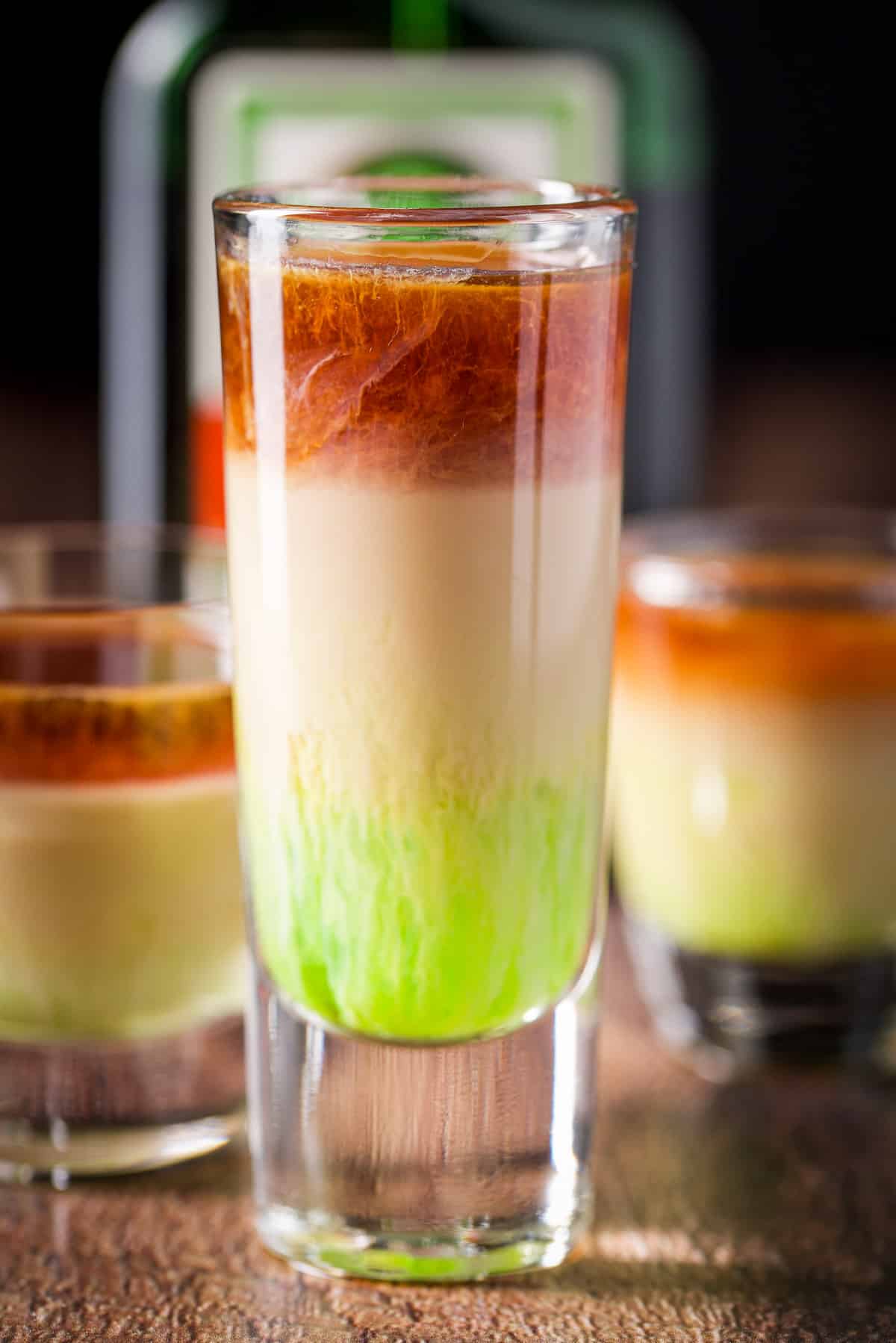 Jagermeister layered into the three glasses with the bottle in back