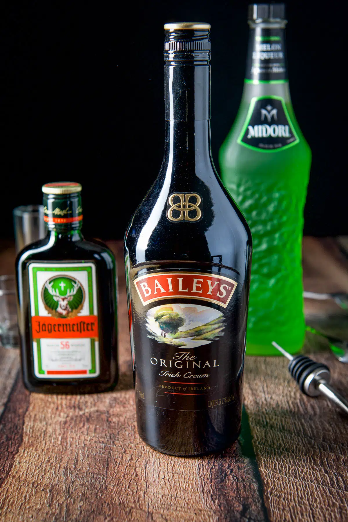 Baileys, Midori and Jagermeister on a wooden table