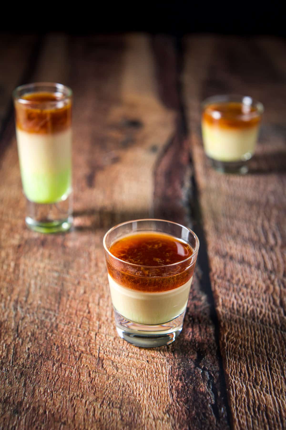 Short glass of the loch ness monster layered shot in front of the other glasses