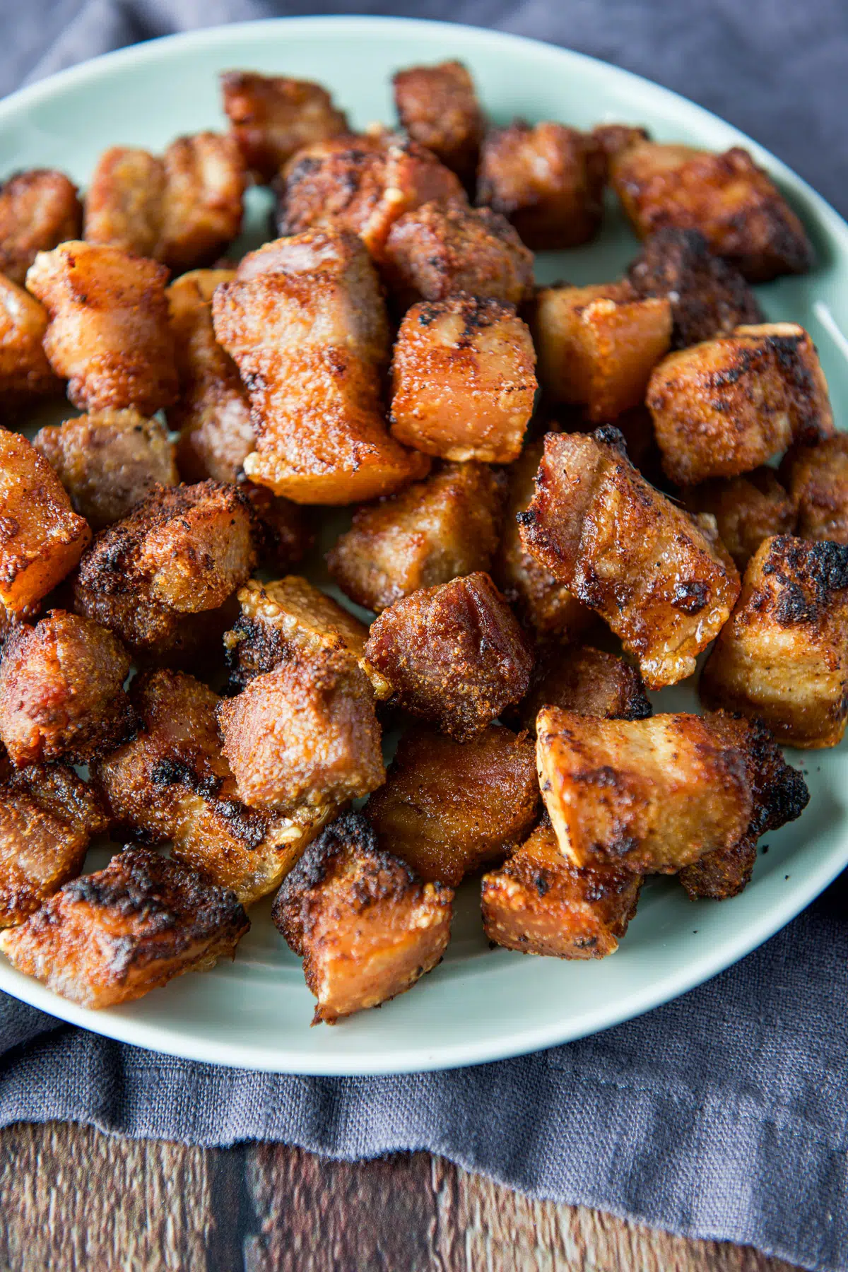 Pork belly bites in a pile on a plate